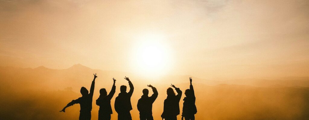 silhouette photo of six persons on top of mountain
